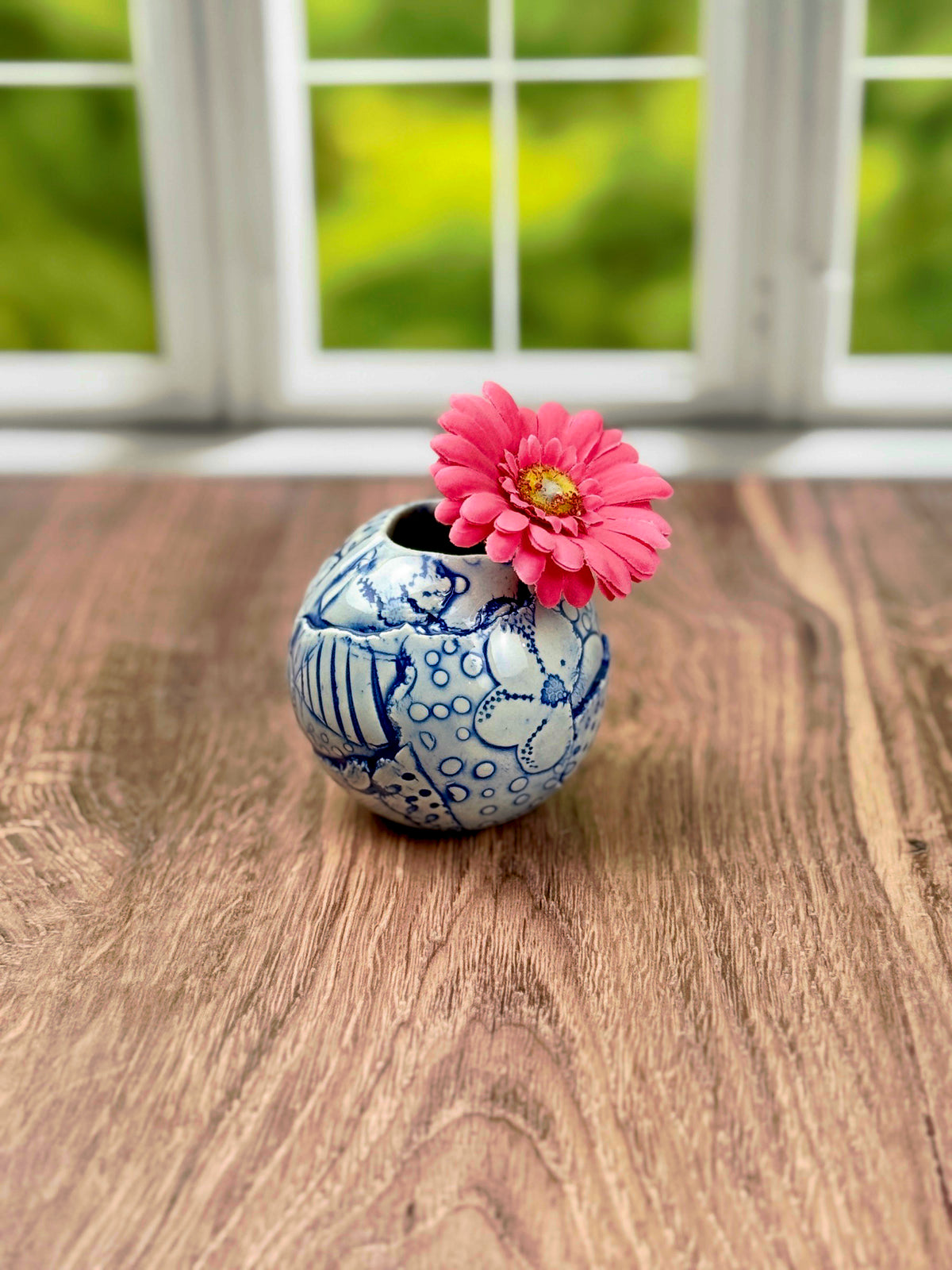 Small round blue bud vase with geometric and flower texture