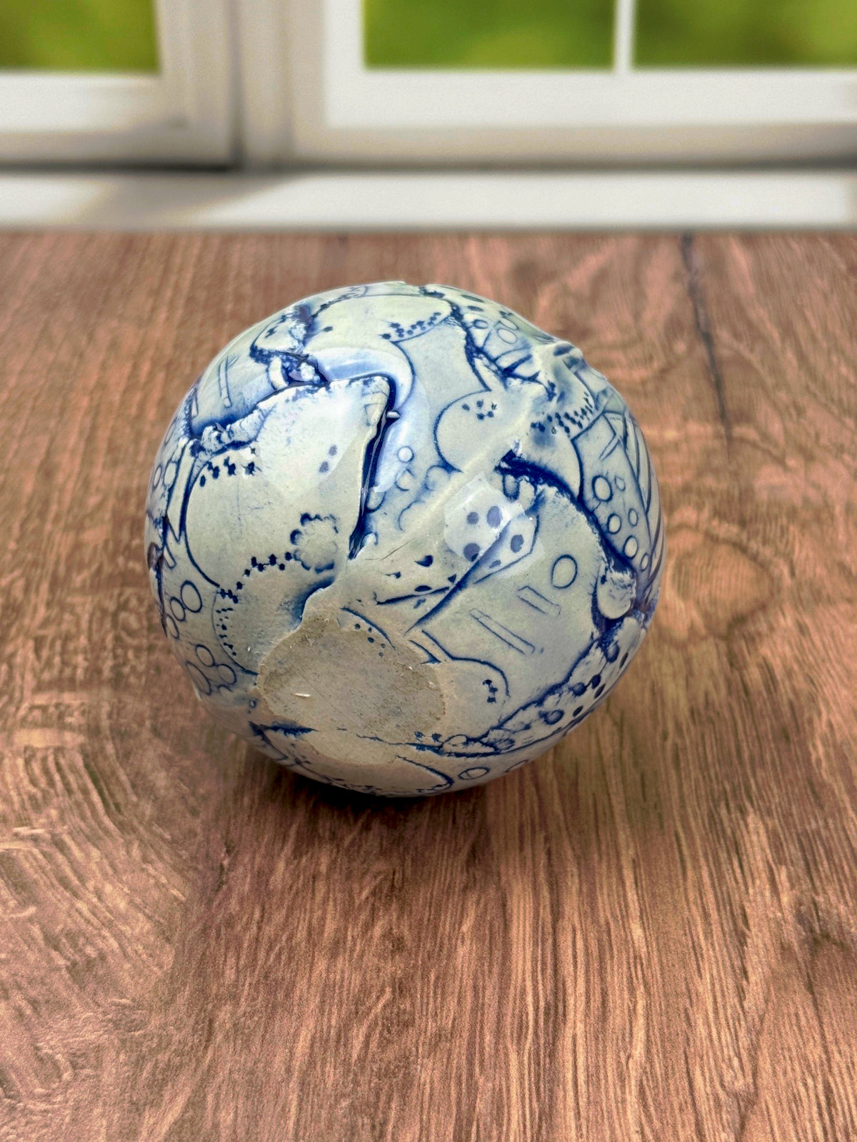 Small round blue bud vase with geometric and flower texture