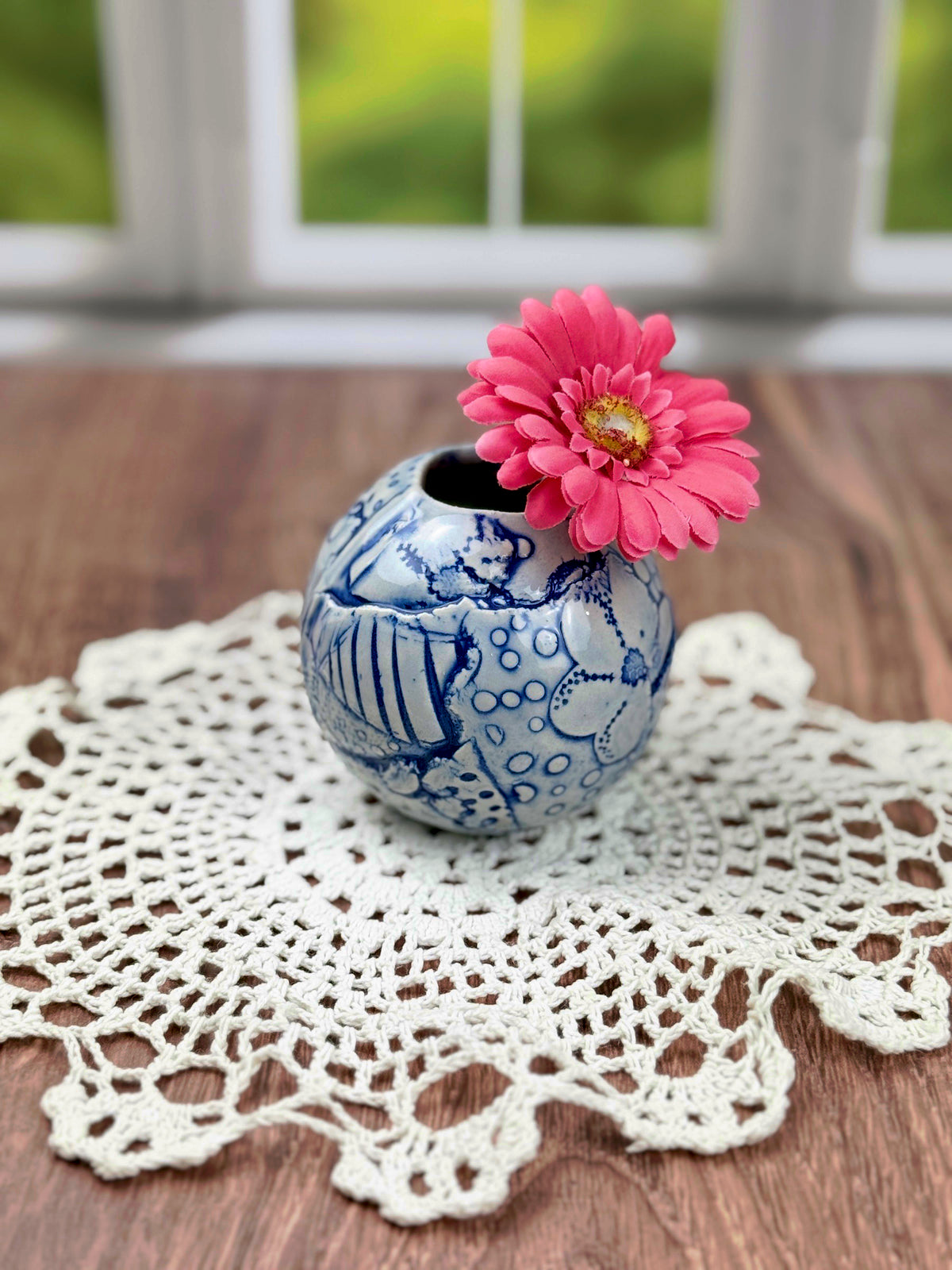 Small round blue bud vase with geometric and flower texture
