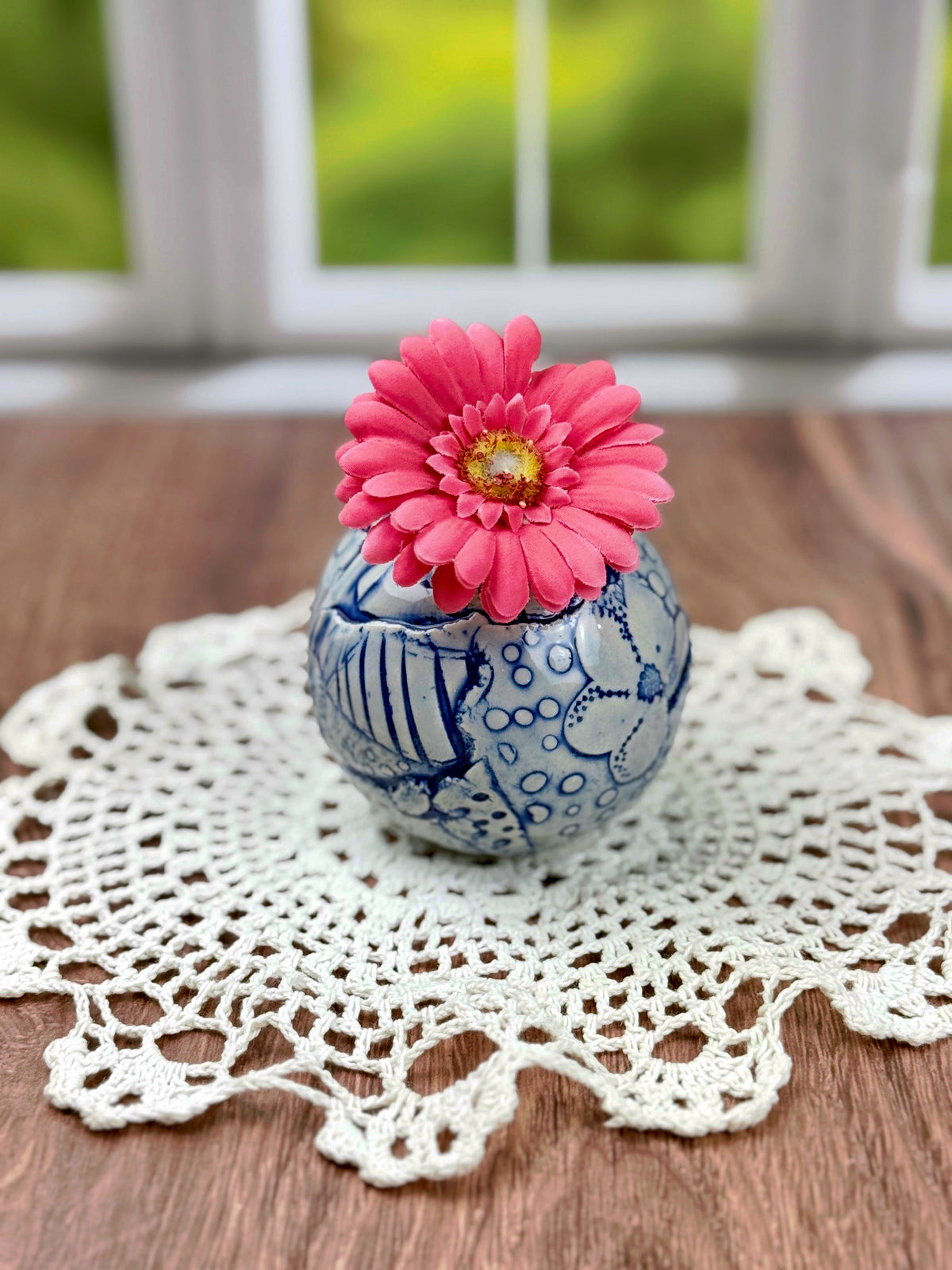 Small round blue bud vase with geometric and flower texture