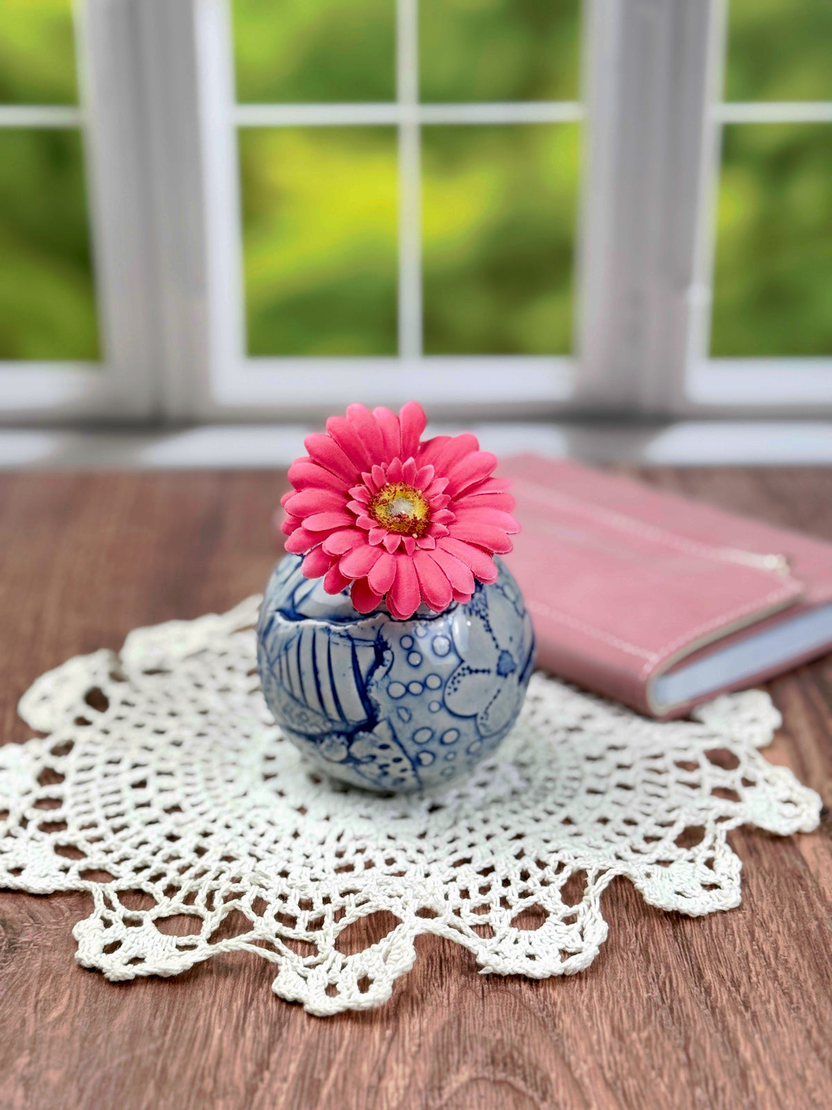 Small round blue bud vase with geometric and flower texture